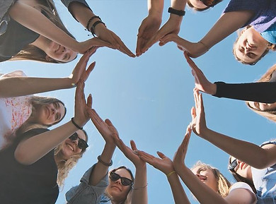 Cheerful girlfriends make a heart shape out of their hands_.jpeg