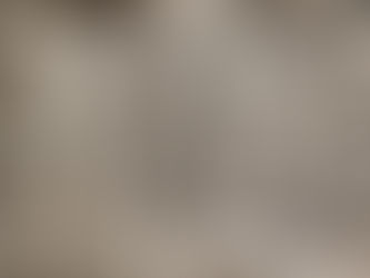 Ancient Celtic depiction of Cernunnos, the horned god, seated cross-legged with stag antlers, holding a torc and a serpent, surrounded by animals.