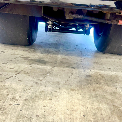 race car being repaired and welded on site at the race track