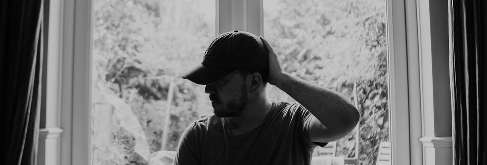 Man with his head at back of head and looking sideways. Posture represents a man struggling with addicting and compulsive behaviours.