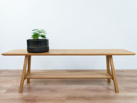 a wooden bench with a potted plant on it