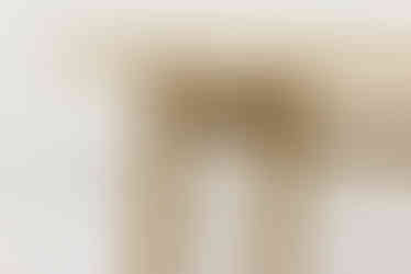 a wooden table with a white wall in the background