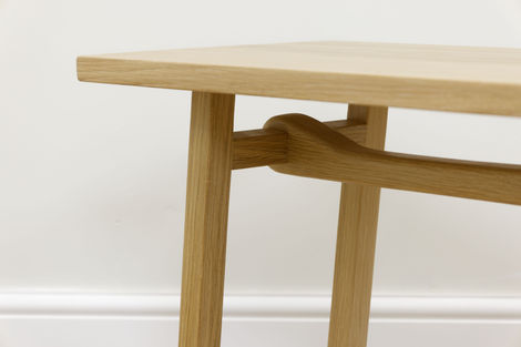 a wooden table with a white wall in the background
