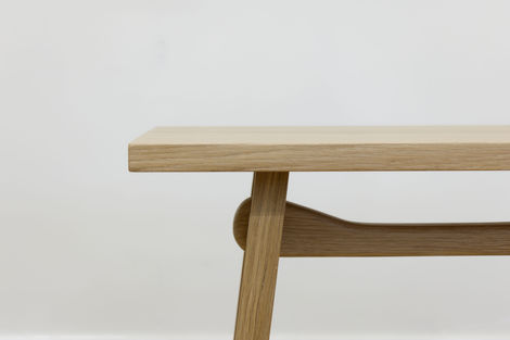 a wooden table with a white wall behind it