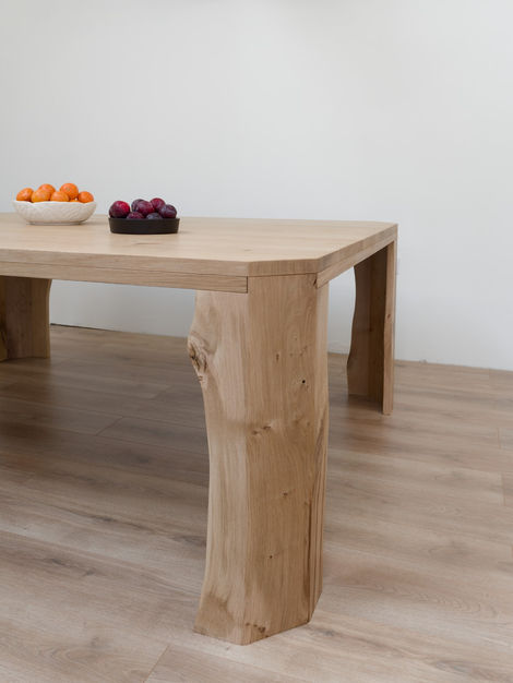 a wooden table with a bowl of fruit on it
