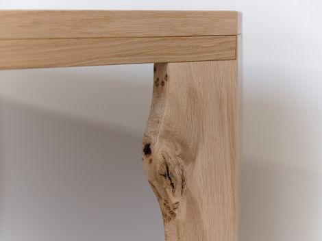 a close up of a live edge wooden table leg