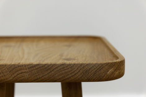 a close up of a wooden table with a white background