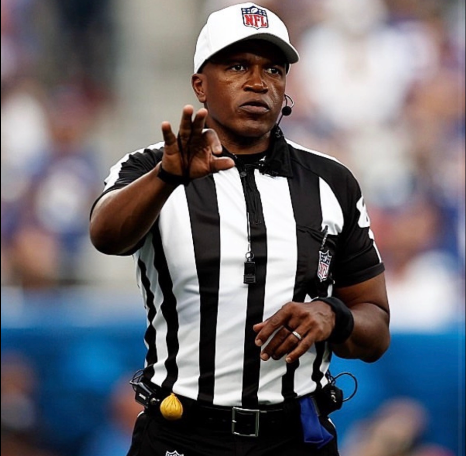 photo of Shawn Smith refereeing a profootball game. 
