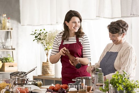 senior and girl cooking in kitchen.jpg