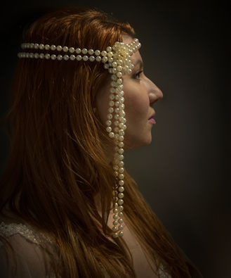 Girl side profile portrait wearing pearl headdress