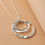 Thumbnail: lange zilveren ketting met grote minimalistische  ronde hanger van world's finest close up