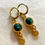 Thumbnail: gold plated oorbellen met groene steentjes en bloem bedel