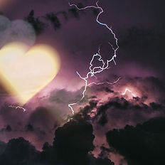 Abstract image of glowing light and branching energy trails against a dark sky, representing feminine healing and renewal
