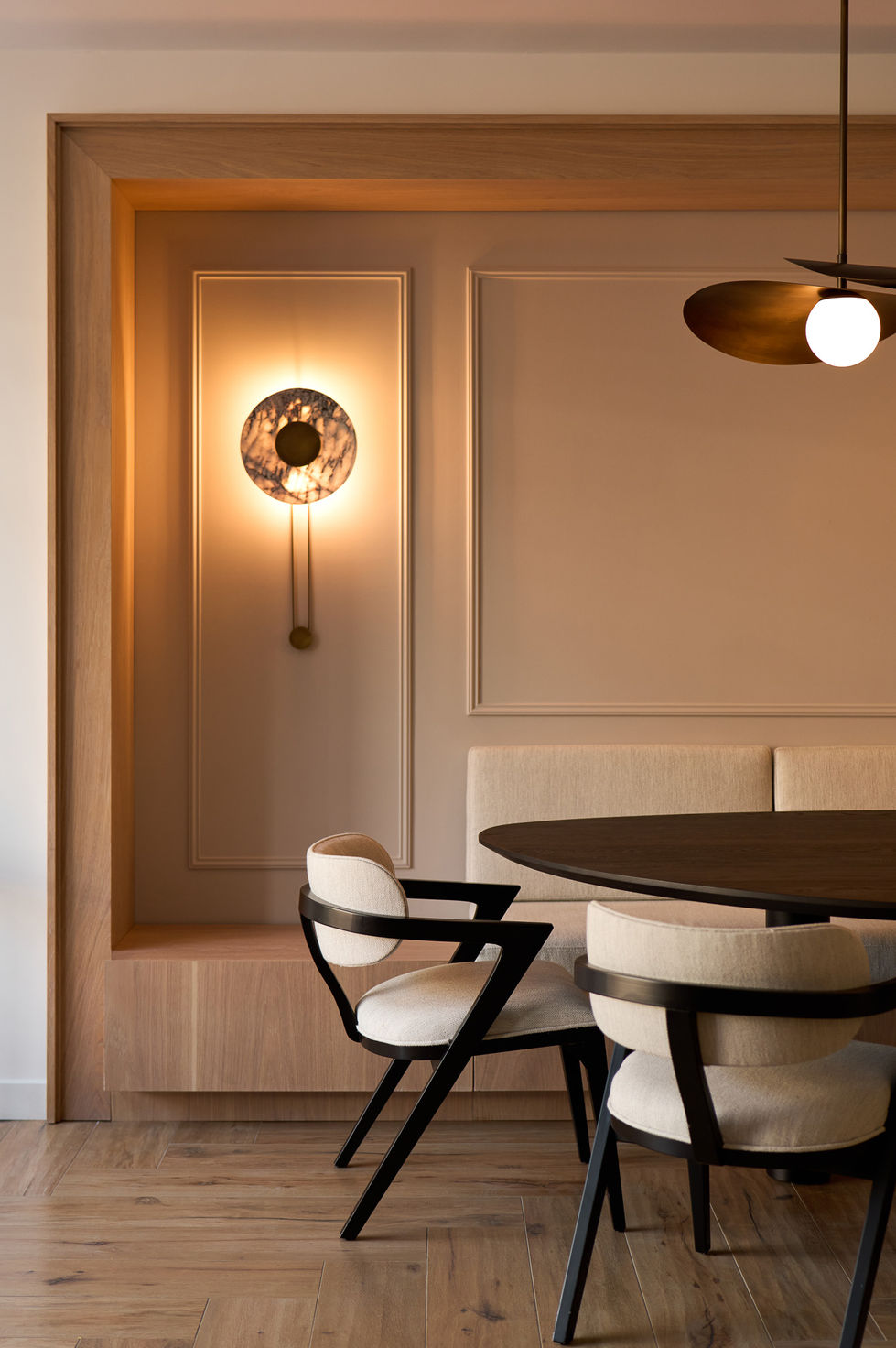 Modern dining area with stylish lighting and furniture.