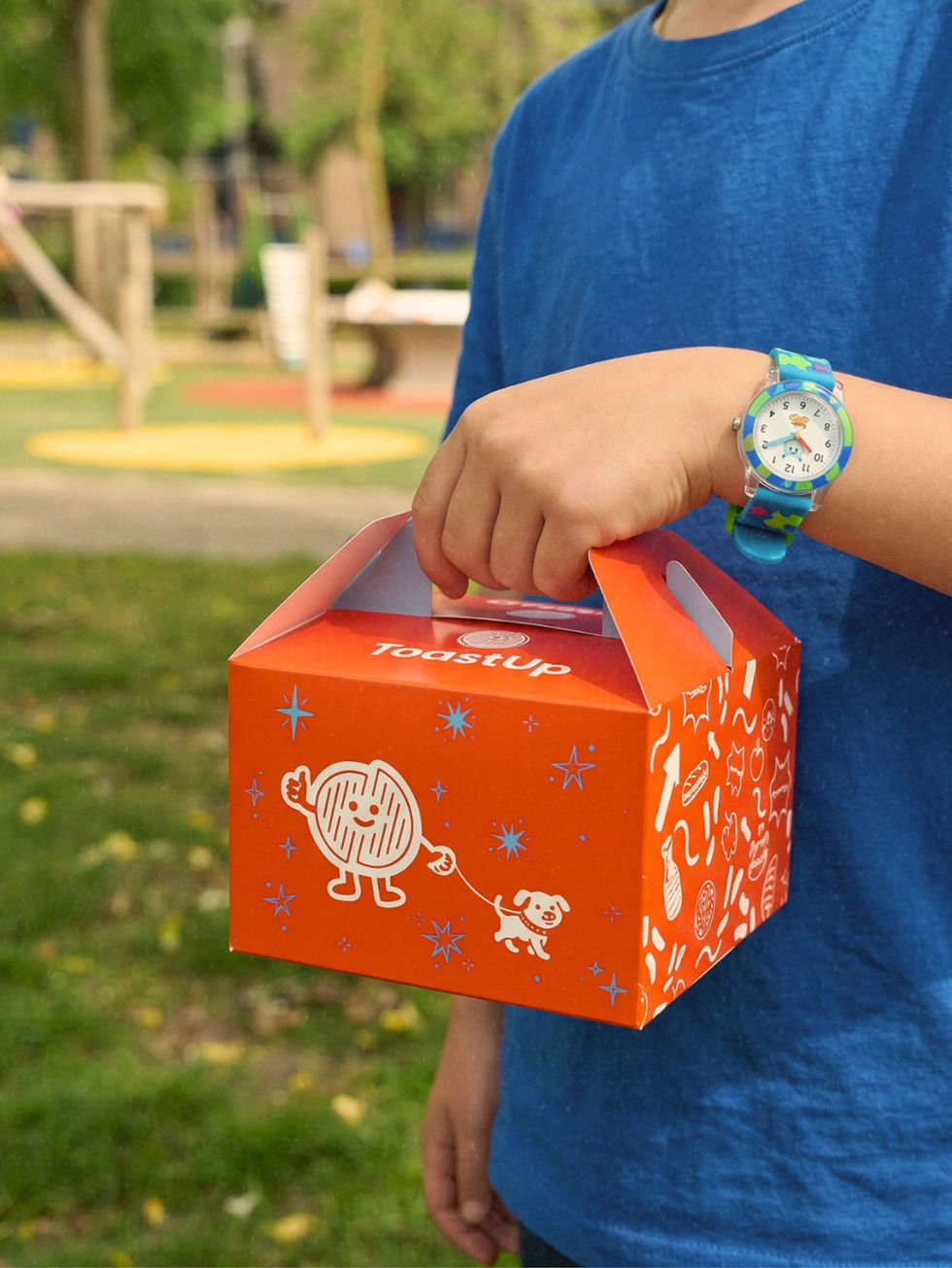 Child holding an orange box with playful design.