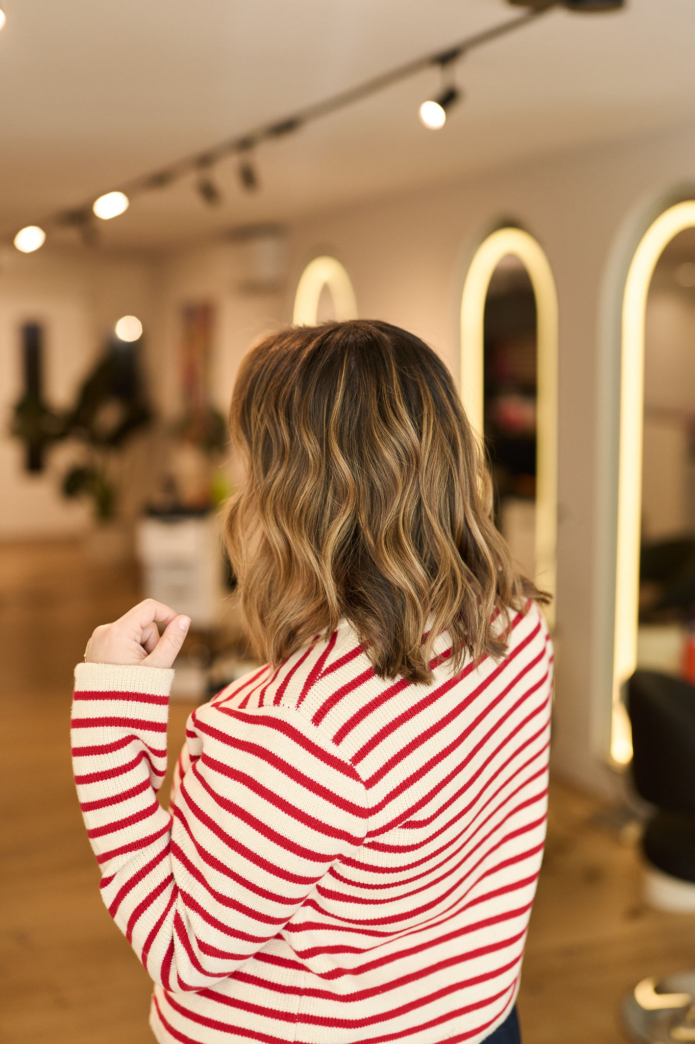Person with wavy hair in a striped shirt.