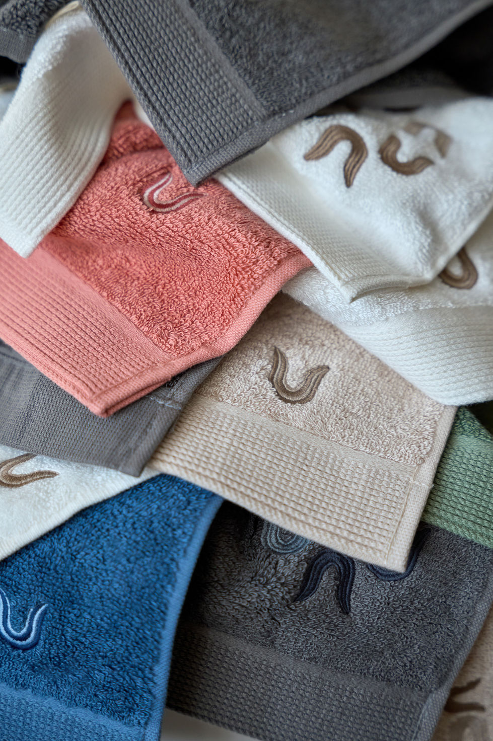 Stack of colorful embroidered towels.