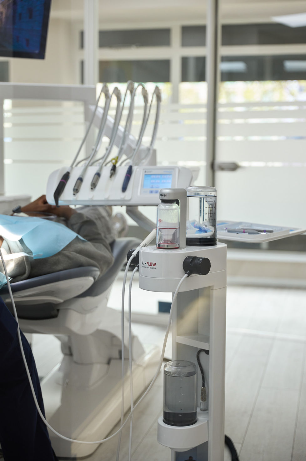 Dental office with patient chair and equipment.