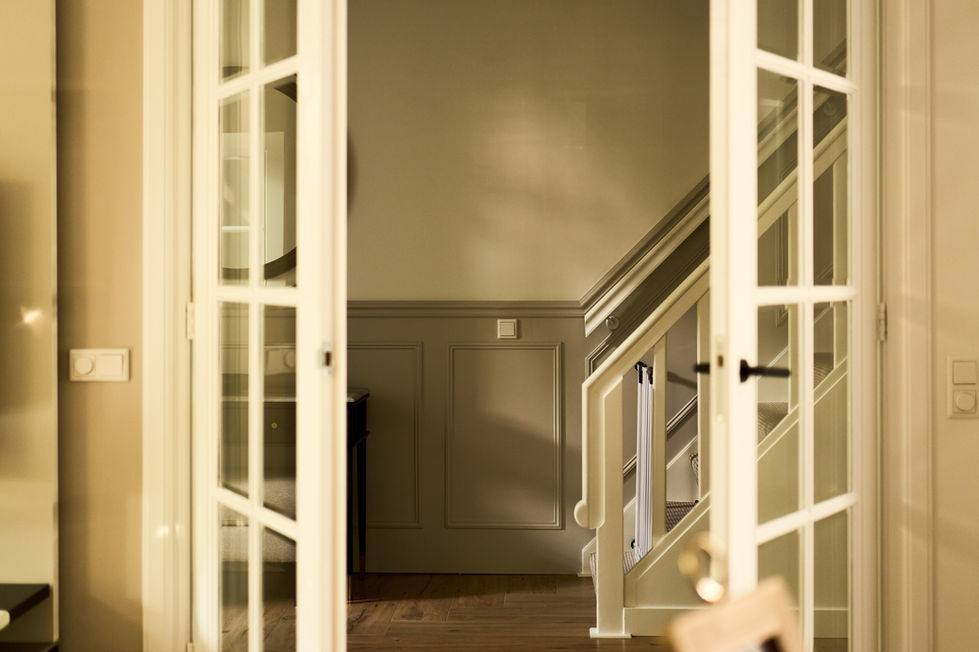 Open French doors leading to a staircase.