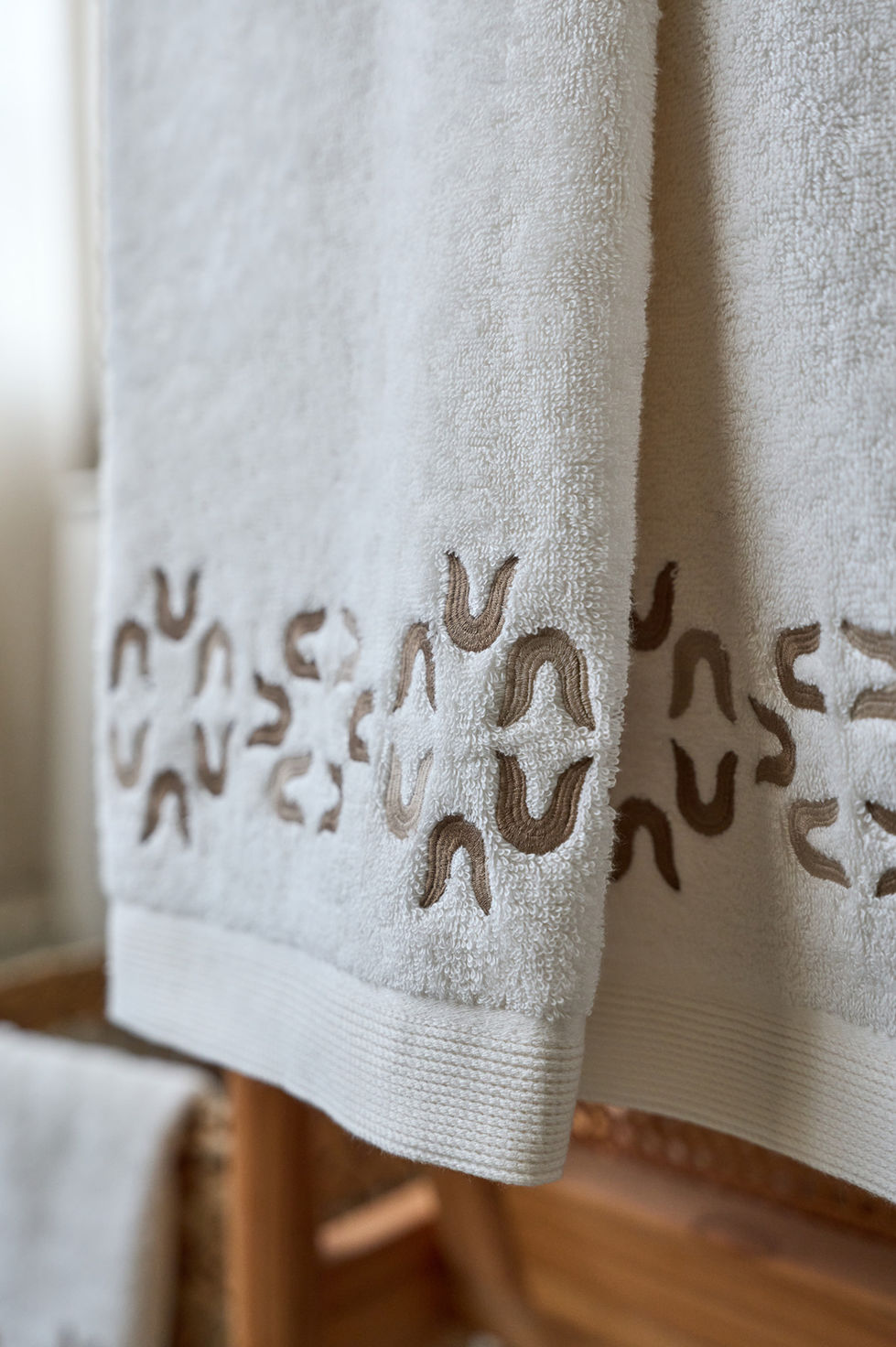White towel with decorative cut-out pattern.