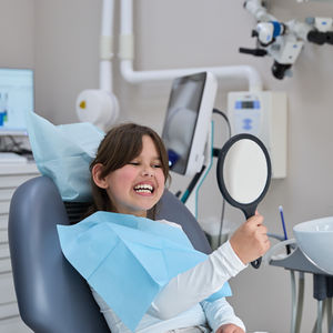 Happy young girl at dentist