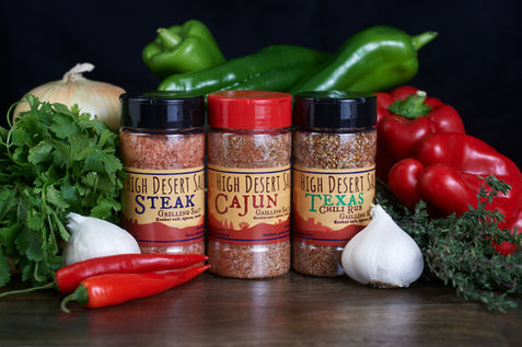 Product photo of spicy salt mixes along with many of the ingredients used in making them. Photos for High Desert Salts, Colorado City, Arizona.