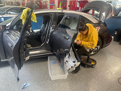 alt="Lucaz Windoalt="Lucaz Window Tinting Fremont technician performing deep-clean prep and ceramic window tint installation in climate-controlled bay for flawless adhesion"