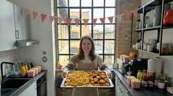 freepik__a-smiling-woman-in-her-early-30s-stands-in-front-o__39874