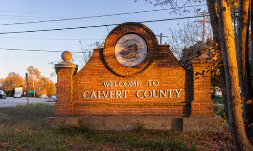 Junk removal and hauling services in Calvert County, Maryland, featuring the Welcome to Calvert County sign at sunset.