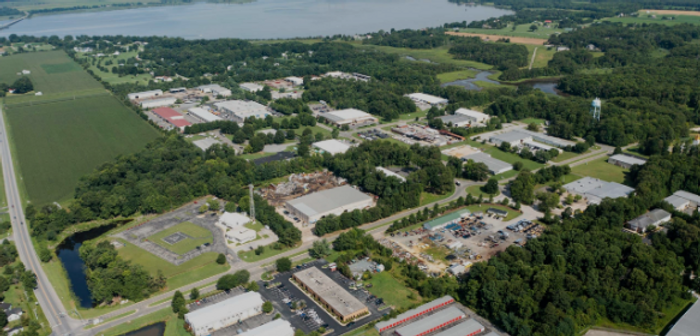 Junk removal and hauling services in Calvert County, Maryland, featuring an aerial view of commercial districts, farmland, and waterfront areas.
