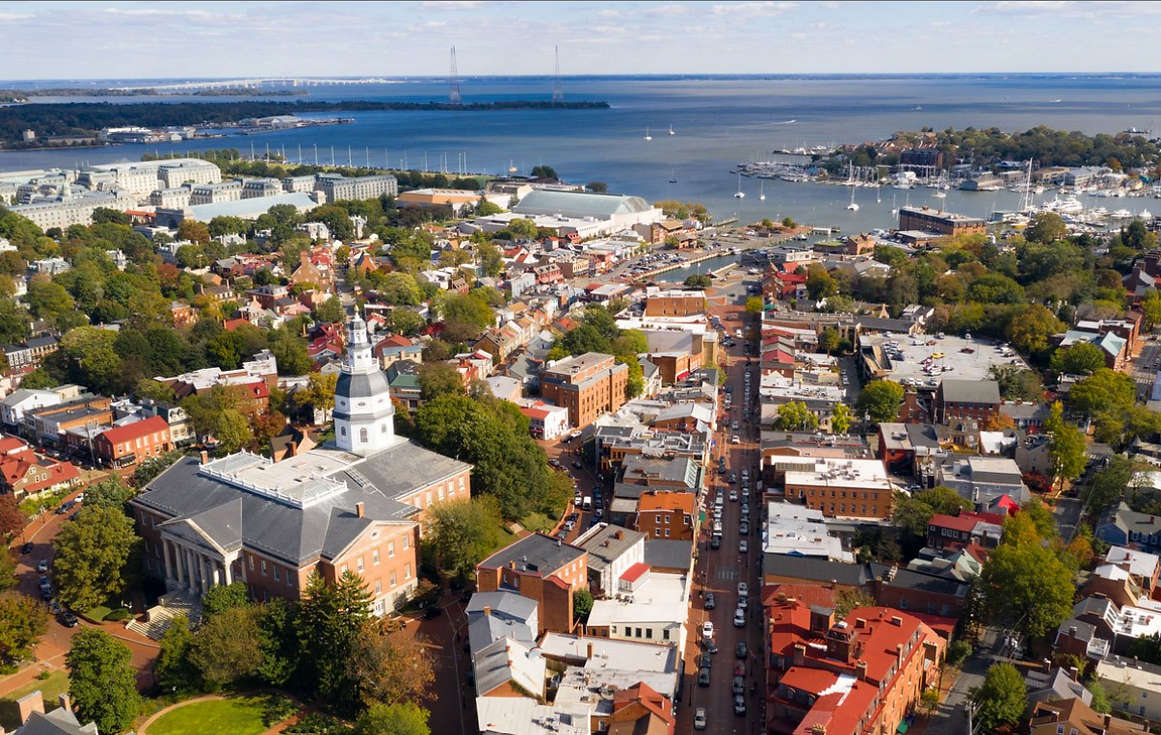 Junk removal and hauling services in Anne Arundel County, Maryland, featuring an aerial view of waterfront neighborhoods and Chesapeake Bay.