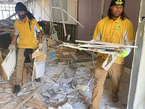 Junkman Removal workers clearing drywall and construction debris during an interior demolition project