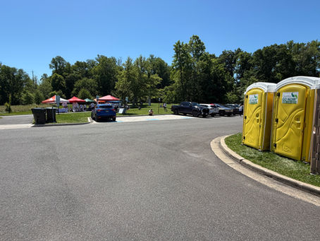Portable toilet rental units strategically placed near parking and event activity area in Maryland