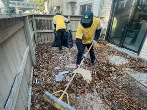 Junkman Removal crew raking leaves and collecting debris during a fall cleanup service in Maryland