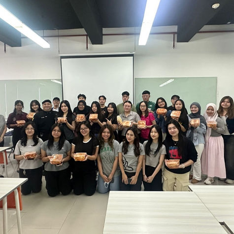Ciputra University students proudly show their homemade kimchi after a Korean culture class.