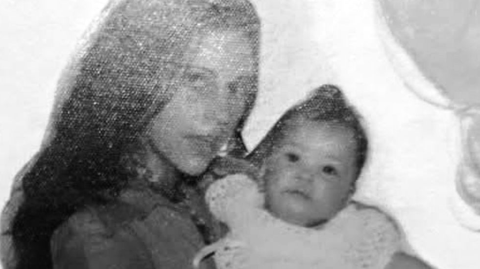 Mother carrying infant.