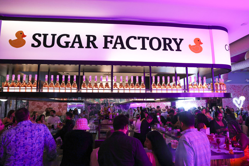 People sitting at the Sugar factory bar 
