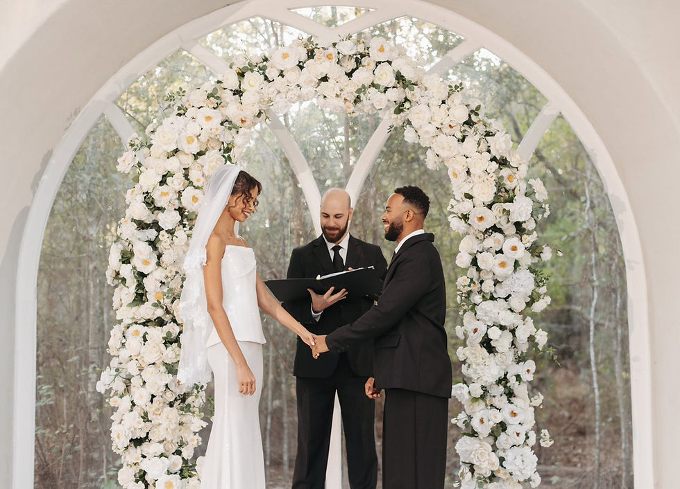 Wedding ceremony under a floral arch