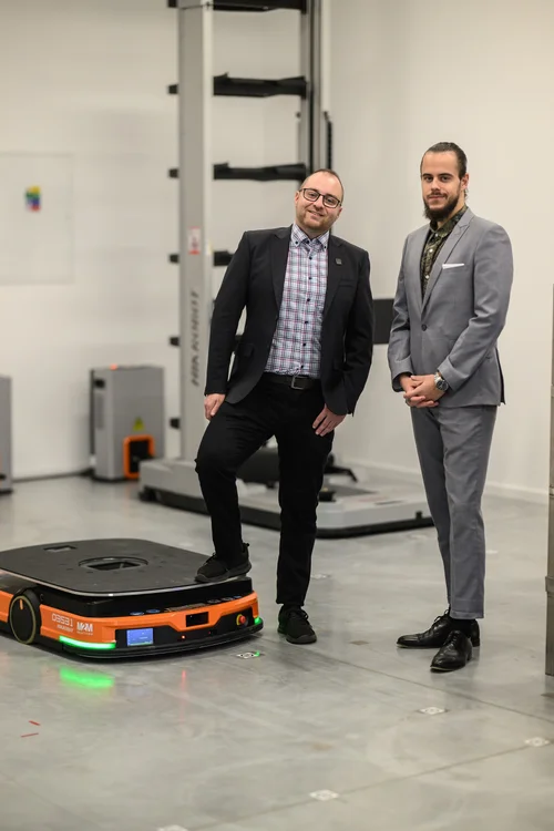 A salesman and a project manager at an AMR robot demonstration.