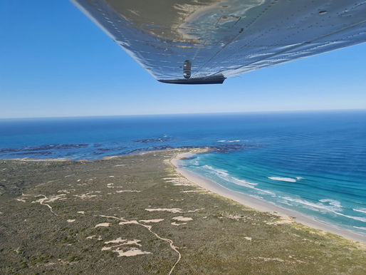 Cessna 210 flying over Walker Bay coastline, Western Cape