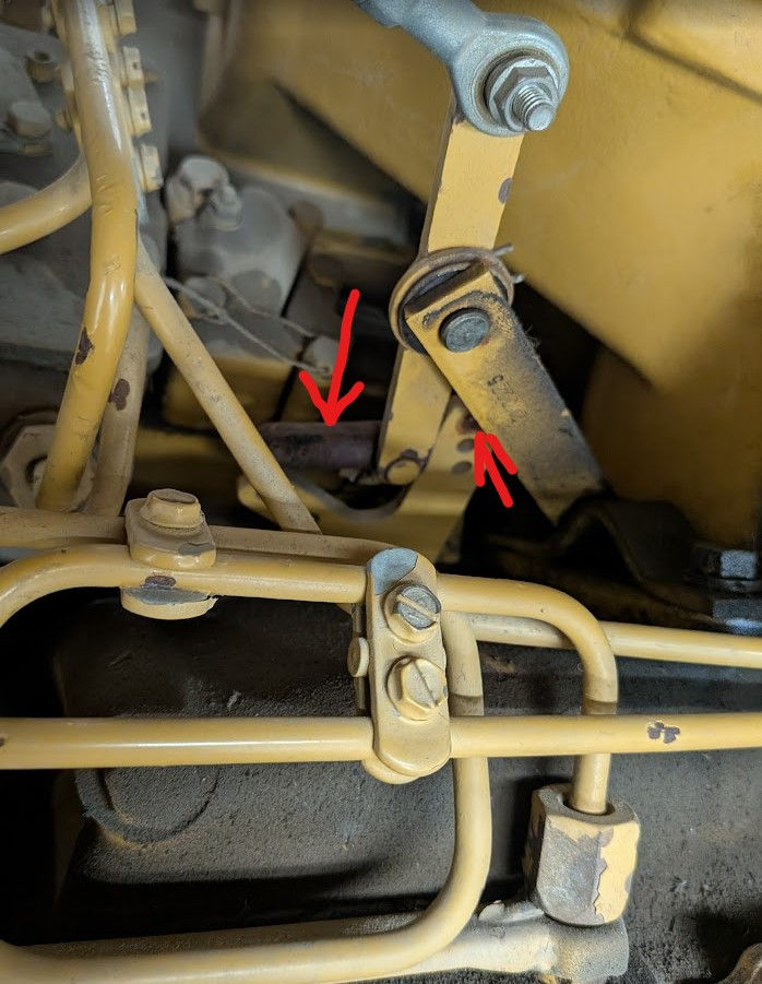 The strap (left arrow) should be connected via a pin in the top hole (right arrow)