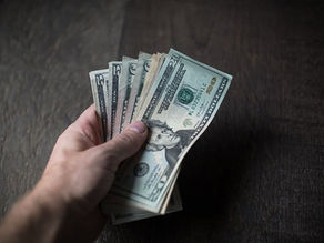 Photo of a Man Holding a Wad of Cash in his hand