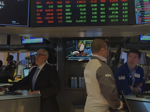 A Group of Businessman Hurdled Around Some Kind of Stock Exchange