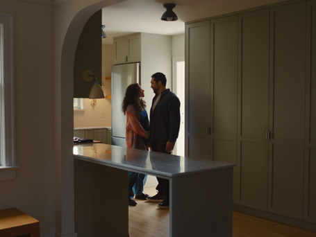 Man And Women Looking At Each Other In Newly Purchased Home 