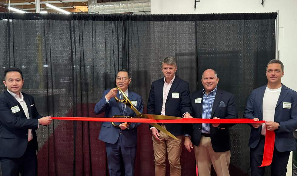 5 people are smiling and one people is cutting a red rope