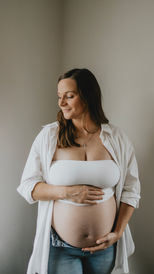 Expectant Mother holding her baby bump with a photo taken by Alte Studios in North Battleford Saskatchewan