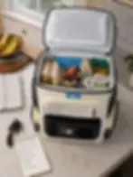 Family lunch and drinks packed inside an electric backpack cooler on a kitchen counter