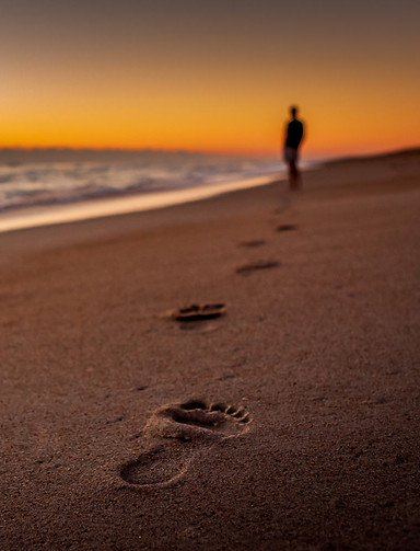 Individual walking on beach contemplating therapy in Arlington, VA