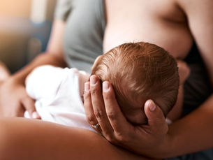 Mother breastfeeding her 1 week old infant