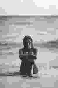 Beach beauty girl sitting at the beach black and white